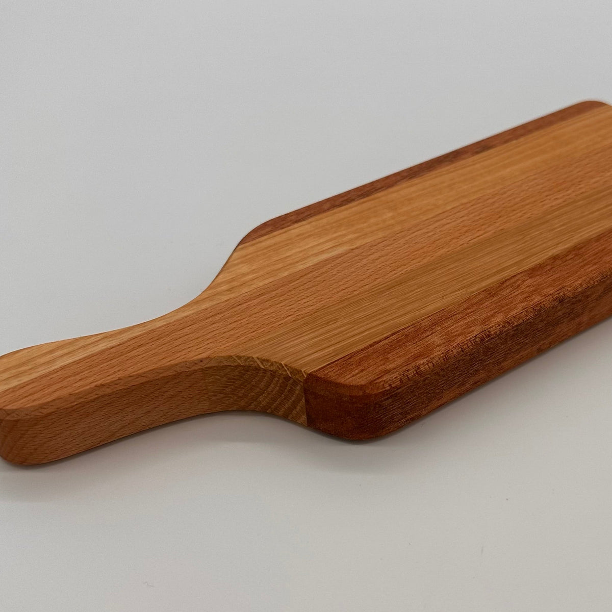 Wooden cutting board on a light gray background