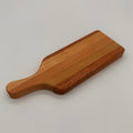 Wooden cutting board with handle on a light gray background