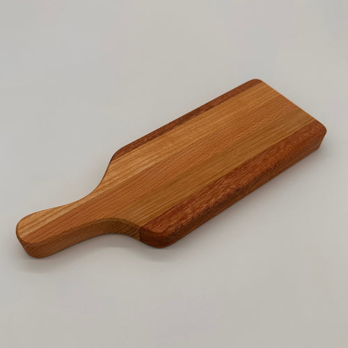 Wooden cutting board with handle on a light gray background