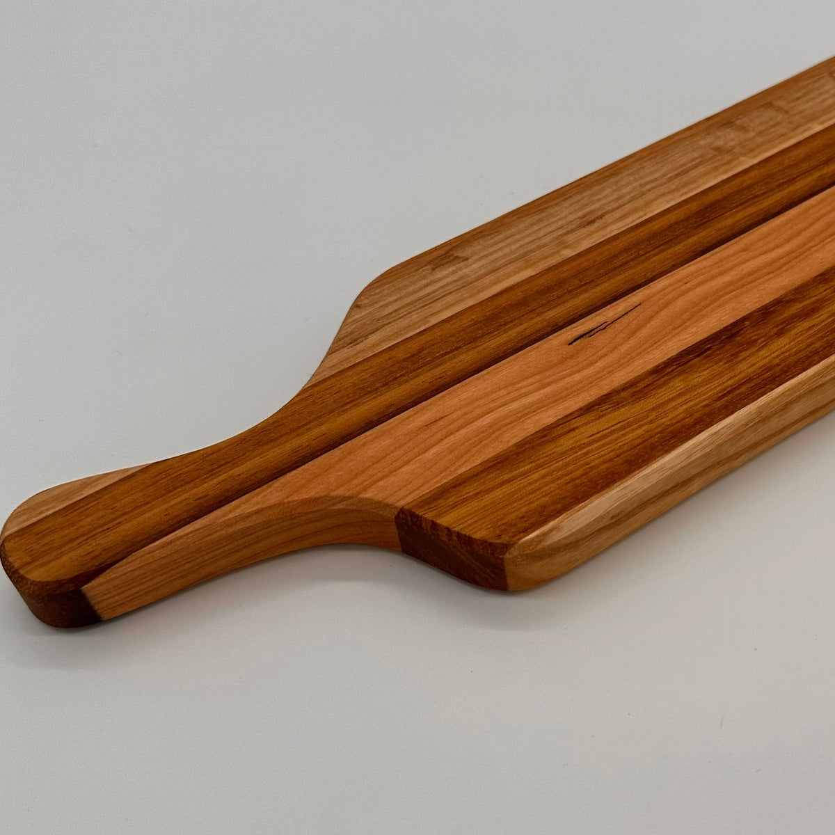 Wooden cutting board on a light gray background