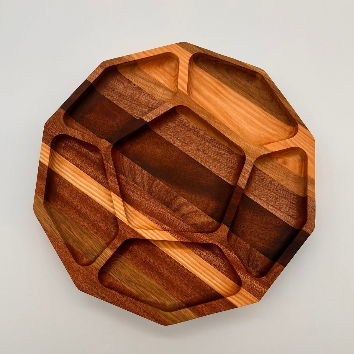 Wooden tray with geometric design on a light gray background
