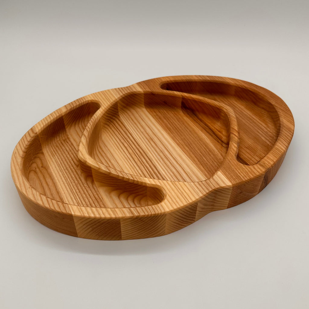 Wooden tray with a unique design on a light gray background