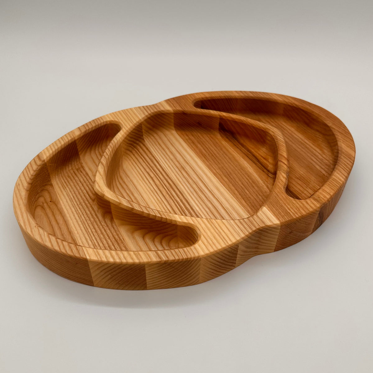 Wooden tray with a unique design on a light gray background