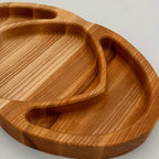 Wooden tray with a natural finish on a light gray background
