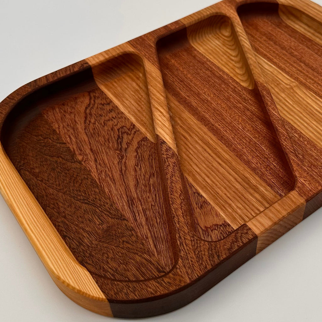 Wooden tray with compartments on a light gray background