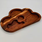 Wooden tray with cloud design on a light gray background