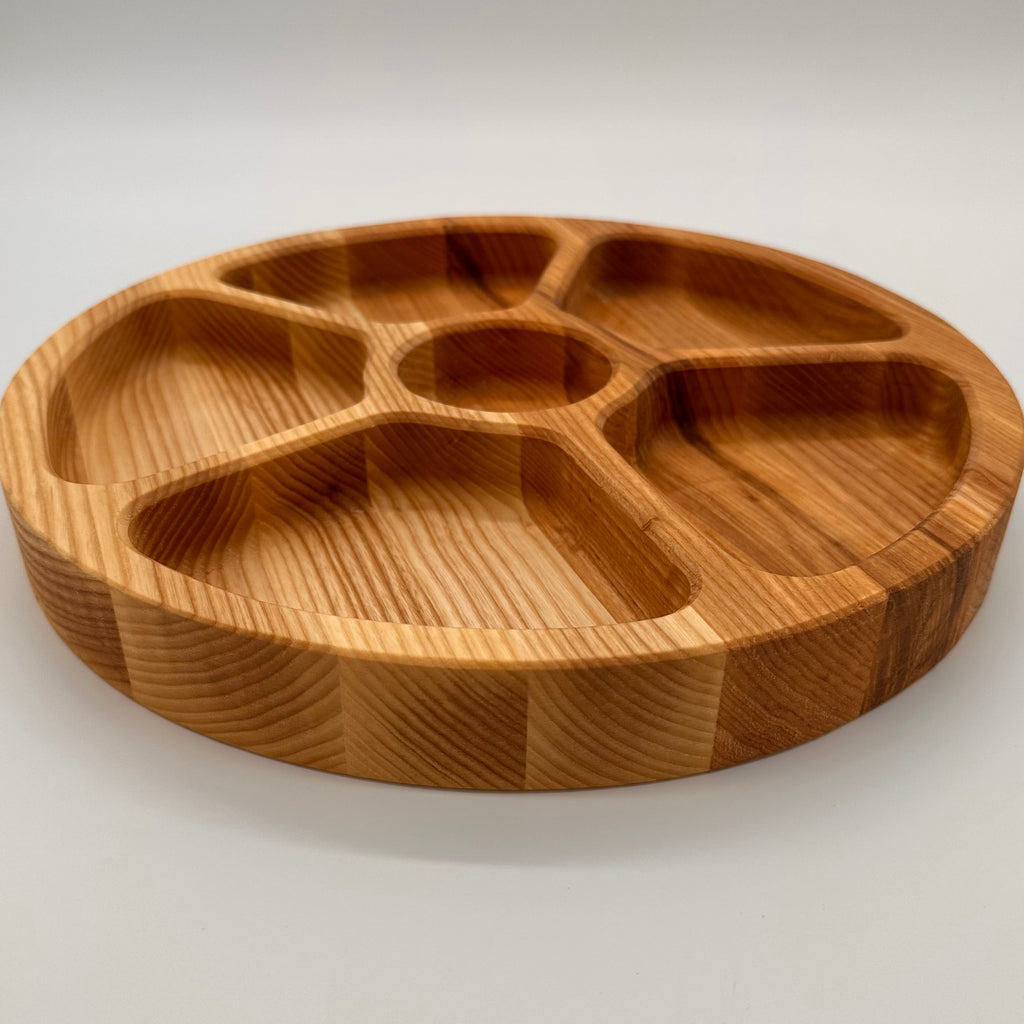 Wooden tray with compartments on a white background