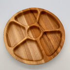 Wooden divided plate on a light gray background