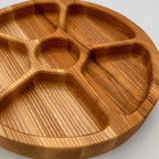 Wooden divided plate on a white background