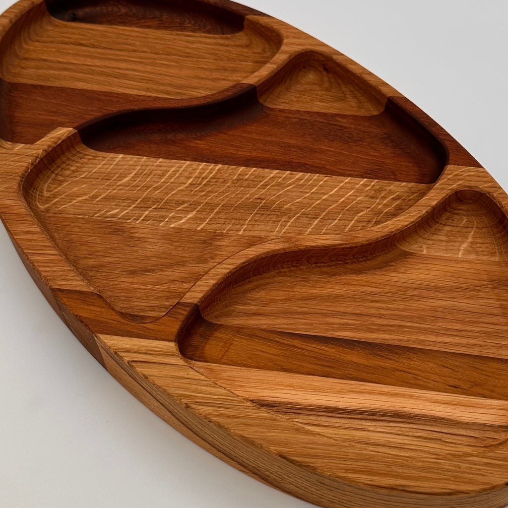 Wooden tray with divided sections on a light gray background