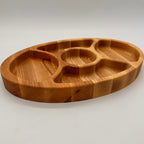 Wooden tray with divided sections on a light gray background