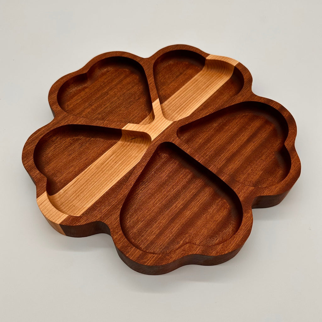 Wooden tray shaped like a clover on a light gray background