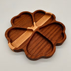 Wooden tray shaped like a clover on a light gray background
