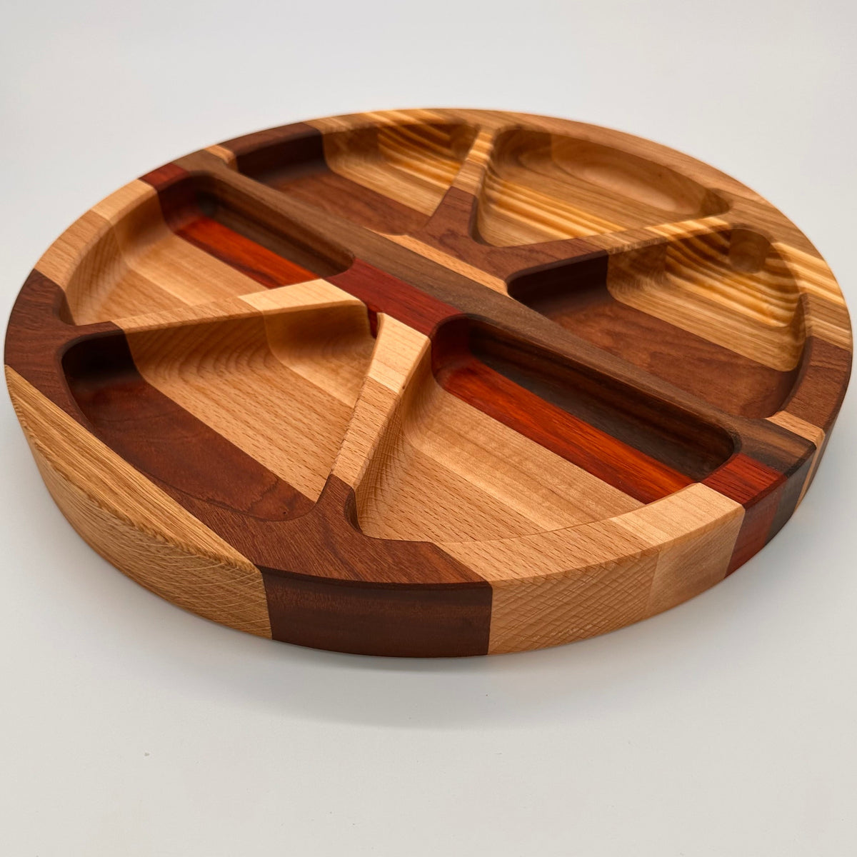 Wooden cutting board with segmented design on a white background