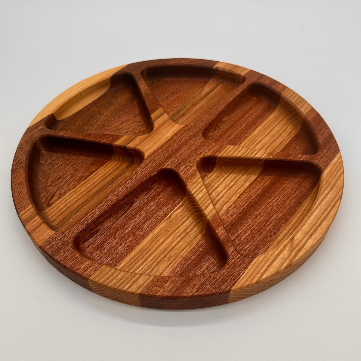 Wooden divided plate on a light gray background