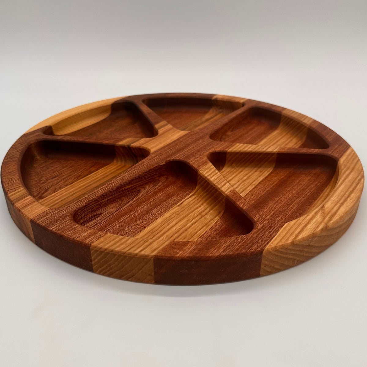 Wooden divided plate on a light gray background