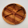 Wooden plate with divided sections on a light gray background