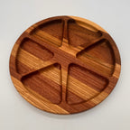 Wooden plate with divided sections on a light gray background