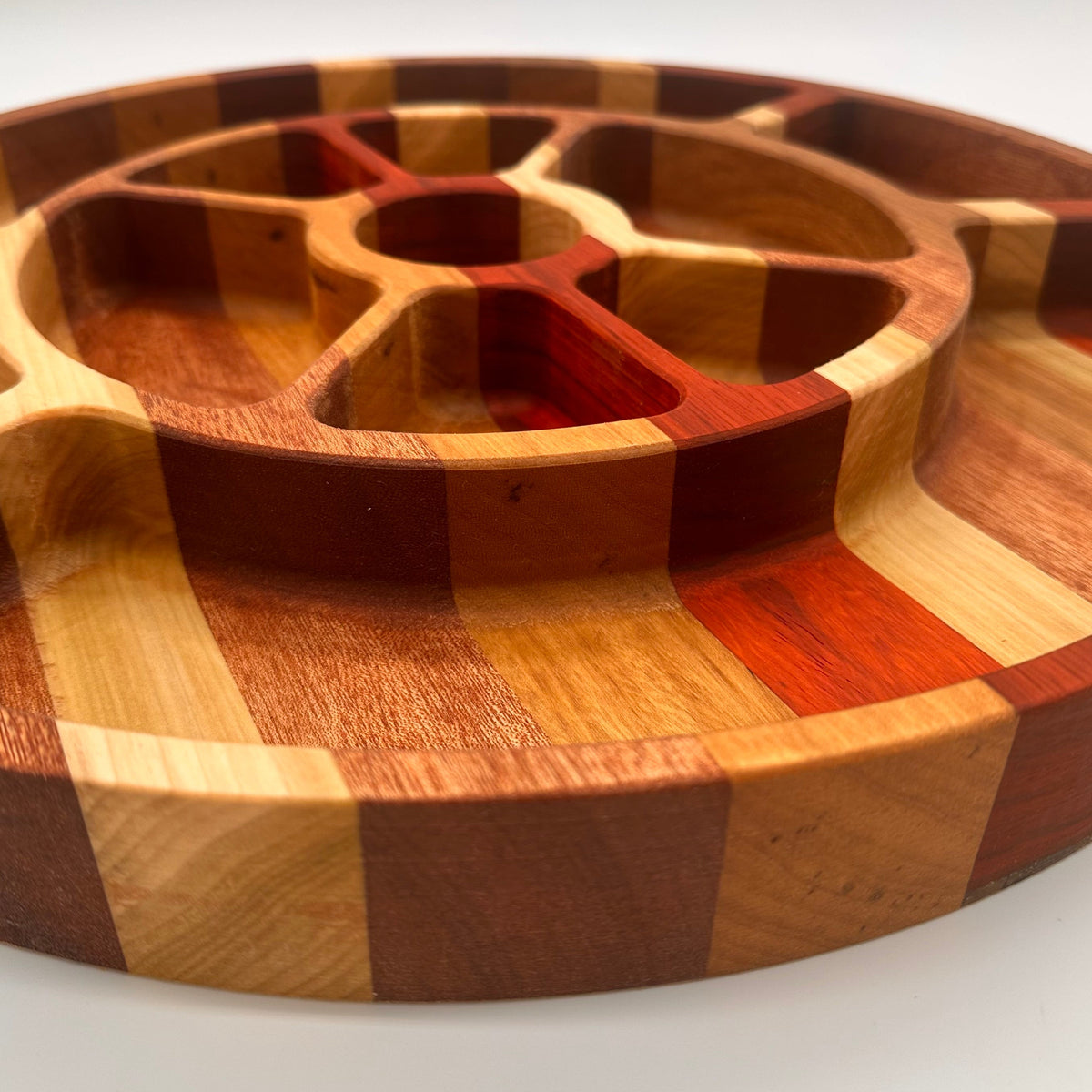 Wooden cutting board with a geometric pattern on a white background