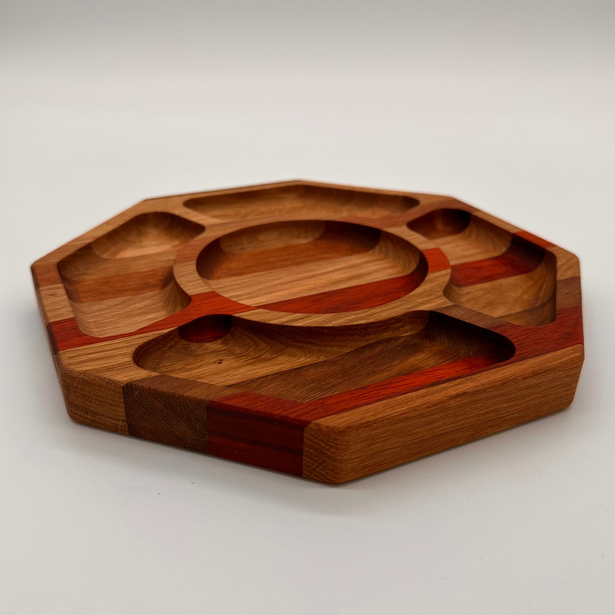 Wooden tray with multiple compartments on a white background
