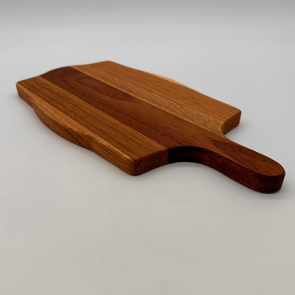 Wooden cutting board with a handle on a white background