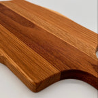 Wooden cutting board with a handle on a white background
