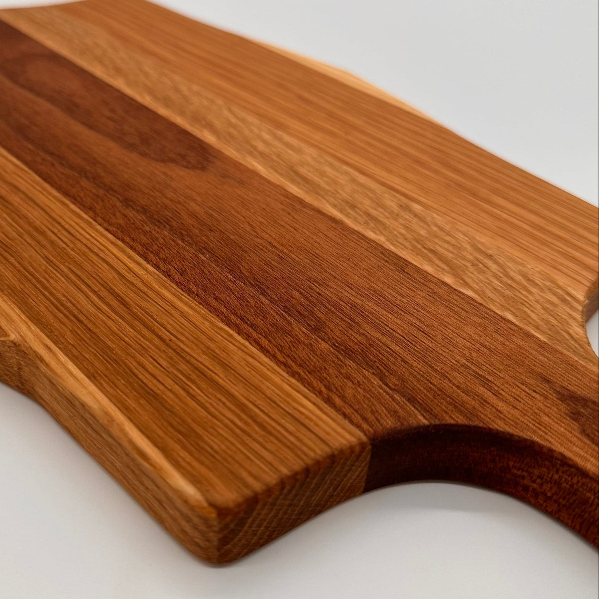 Wooden cutting board with a handle on a white background