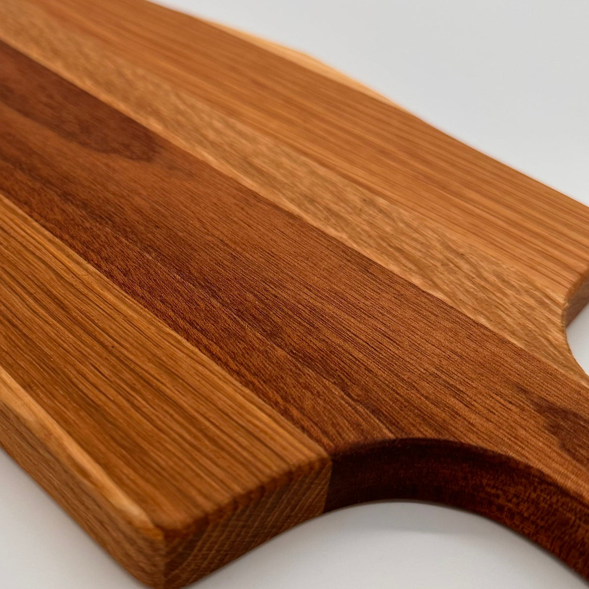 Wooden cutting board with a handle on a white background