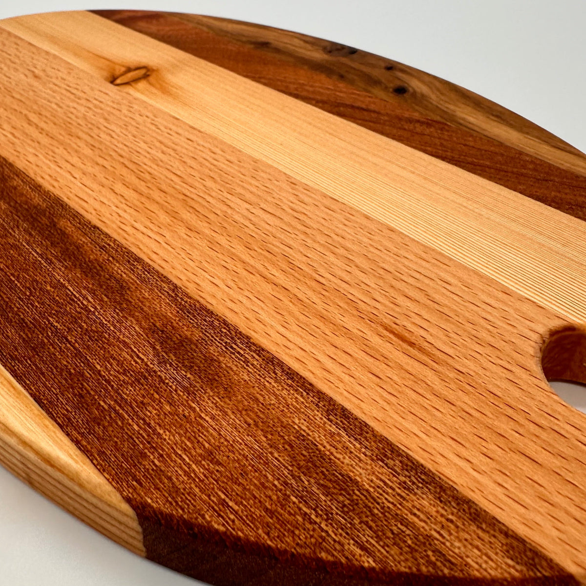 Wooden cutting board with a handle on a white background