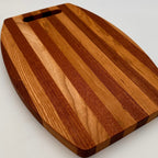Wooden cutting board with a striped pattern on a light gray background