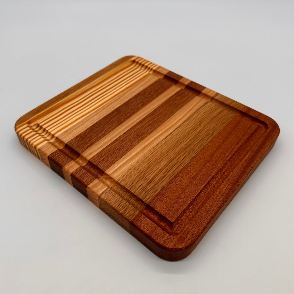 Wooden cutting board with a striped pattern on a light gray background