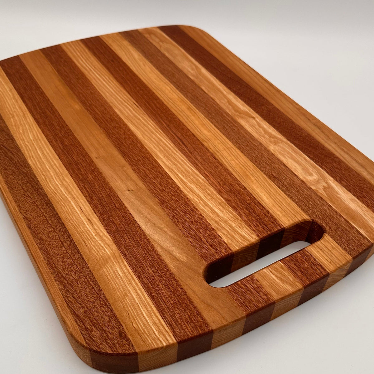 Wooden cutting board with a handle on a white background