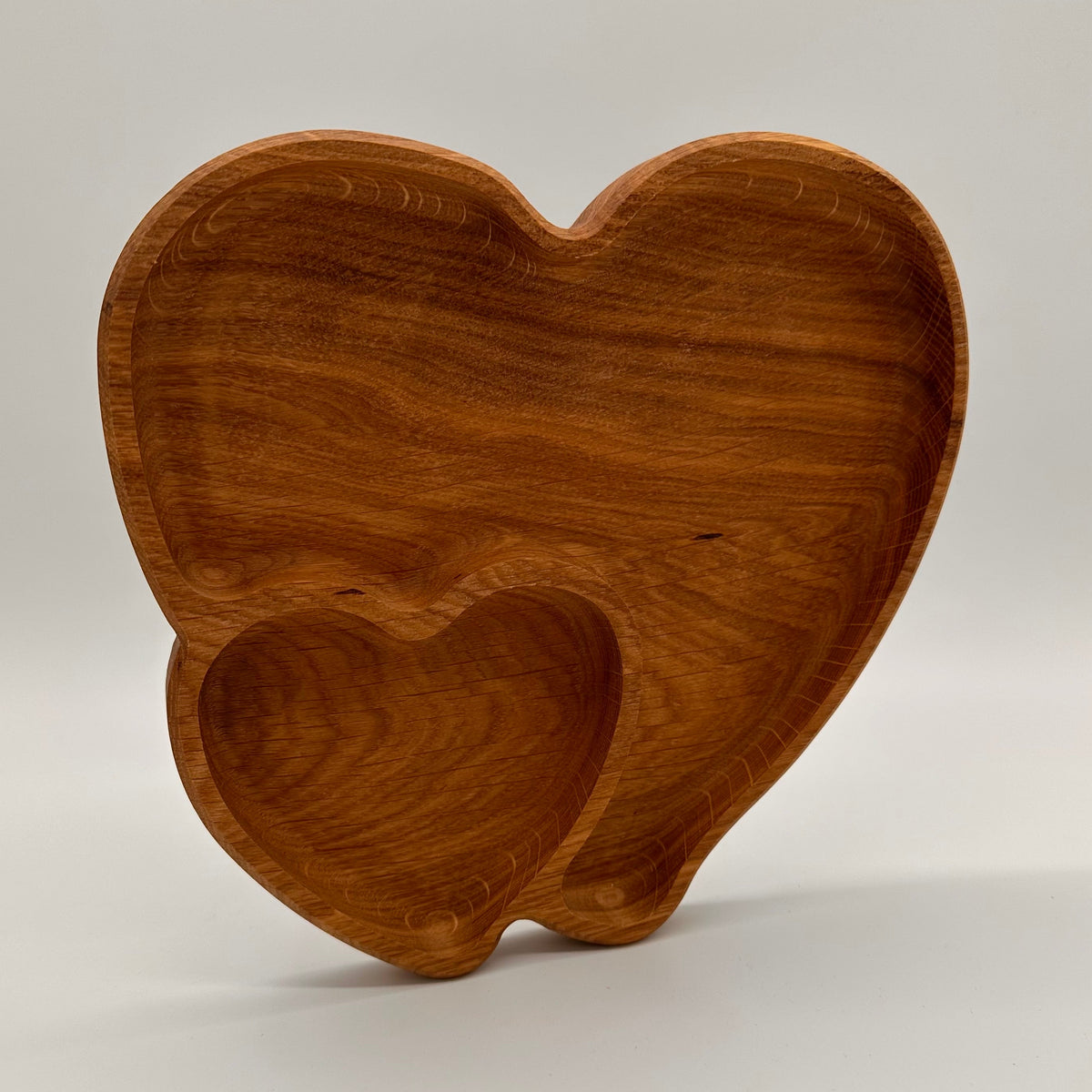 Wooden tooth-shaped object on a light gray background