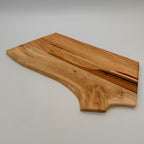 Wooden cutting board with a natural finish on a plain background