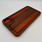 Wooden cutting board with a red stripe on a gray background
