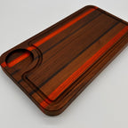 Brown rectangular object with a glossy finish on a light gray background