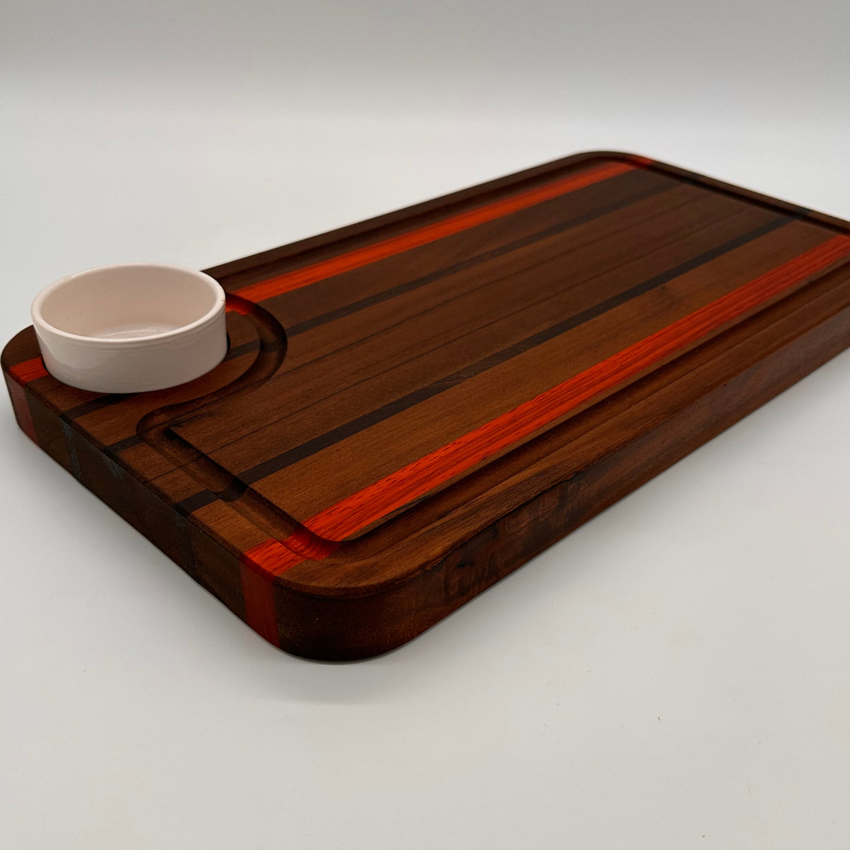 Wooden cutting board with a cup holder on a white background