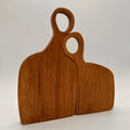 Two wooden cutting boards with handles on a light gray background