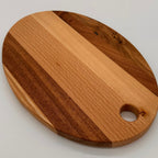 Wooden cutting board with a hole on a light gray background