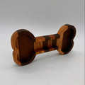Wooden dumbbell-shaped object on a gray background