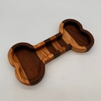 Wooden dumbbell-shaped object on a light gray background