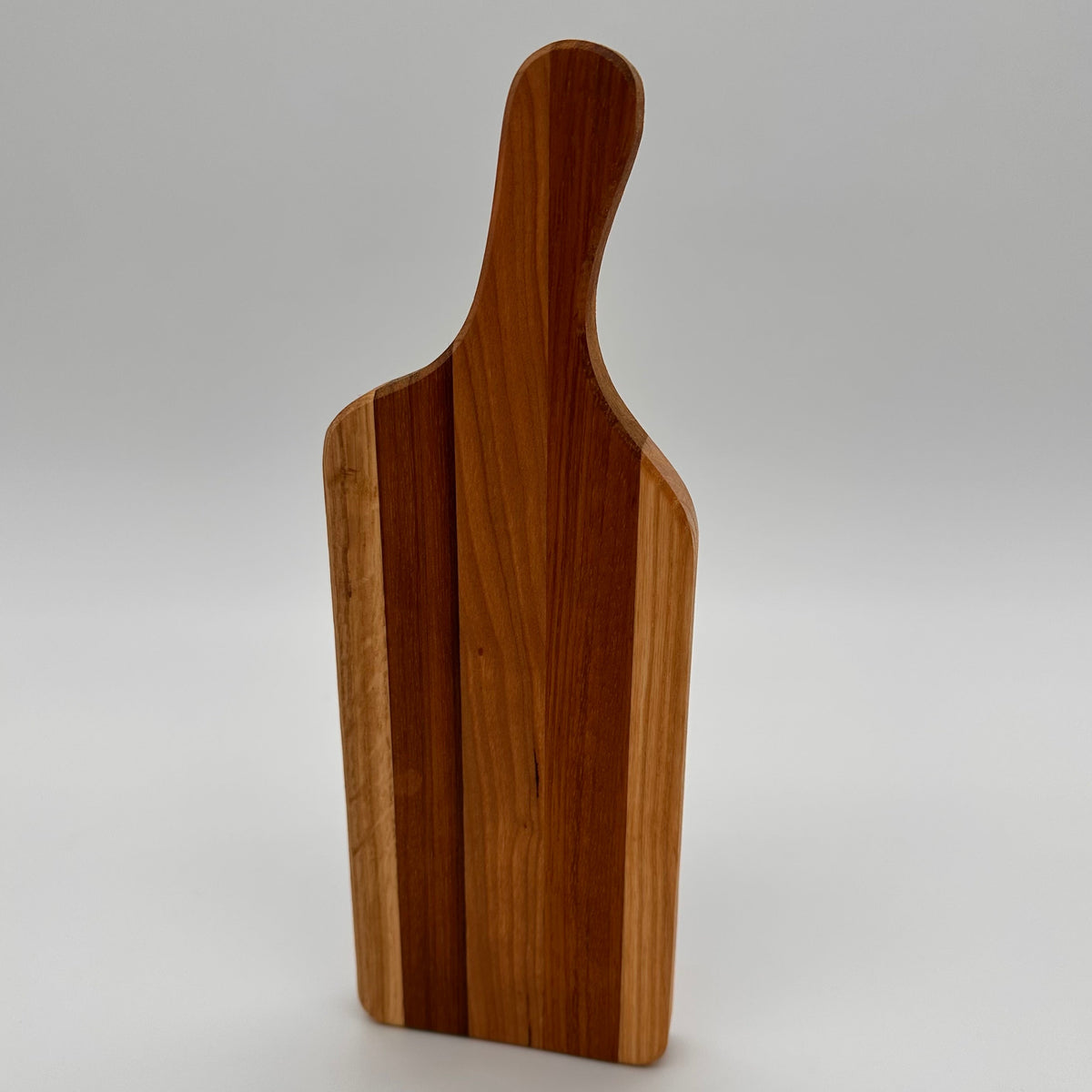 Wooden cutting board with a handle on a white background