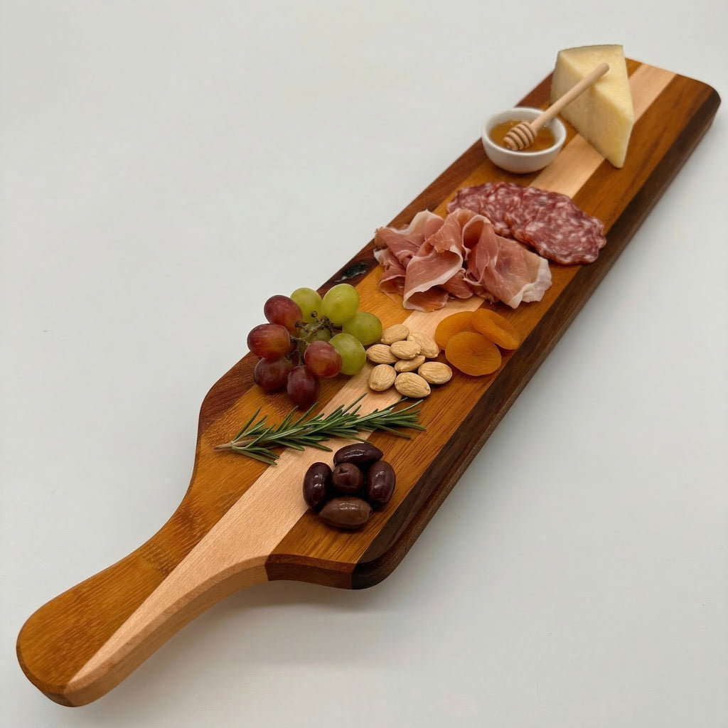 Wooden charcuterie board with meats, cheese, fruits, and nuts on a white background
