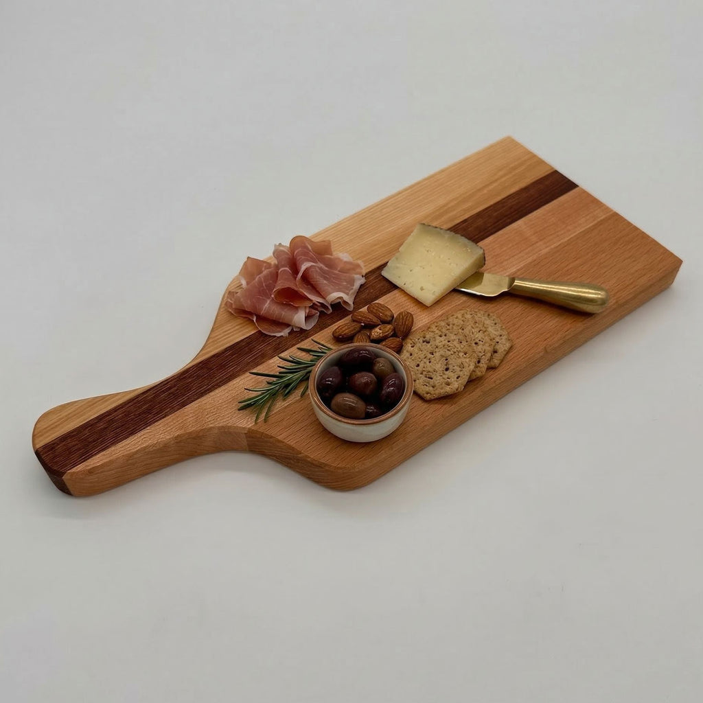 Wooden charcuterie board with prosciutto, cheese, nuts, and olives on a white background