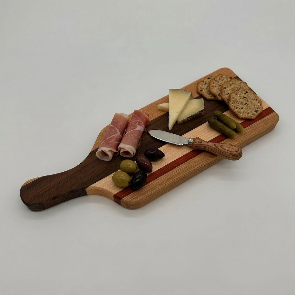 Wooden charcuterie board with cured meats, cheese, olives, and bread on a white background