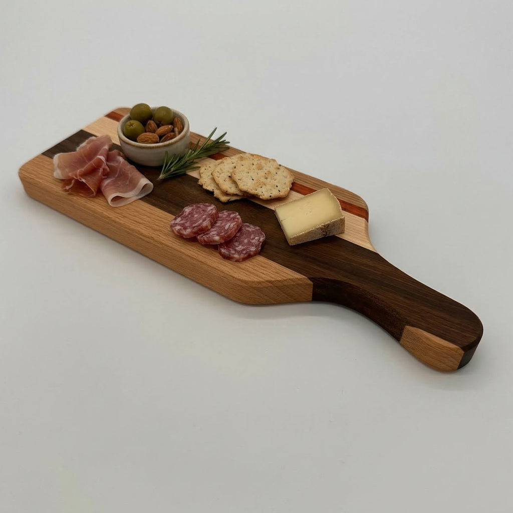 Wooden charcuterie board with cured meats, cheese, and olives on a white background