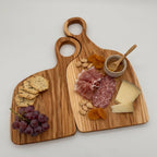 Two wooden cutting boards with assorted food items on a light gray background